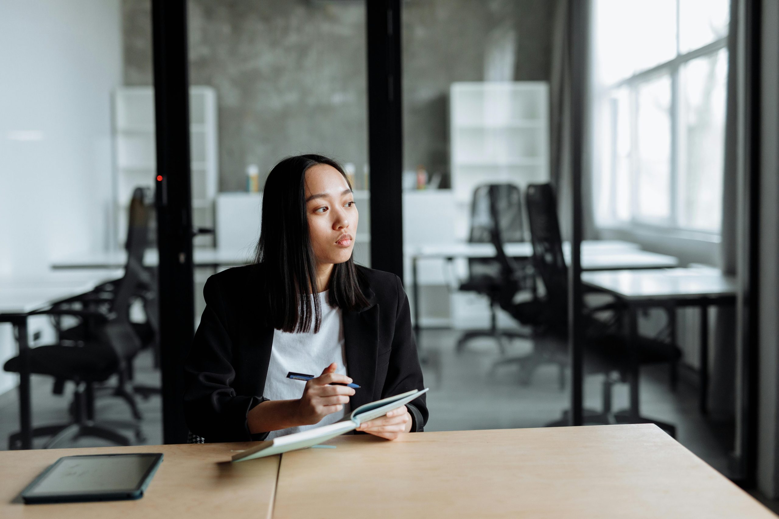 10 Dumb-Smart Financial Questions | girl thinking with a pen and notebook